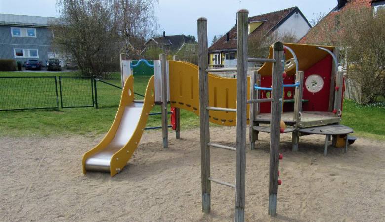 En lekplats för barn med rutschkana och klätterställning.